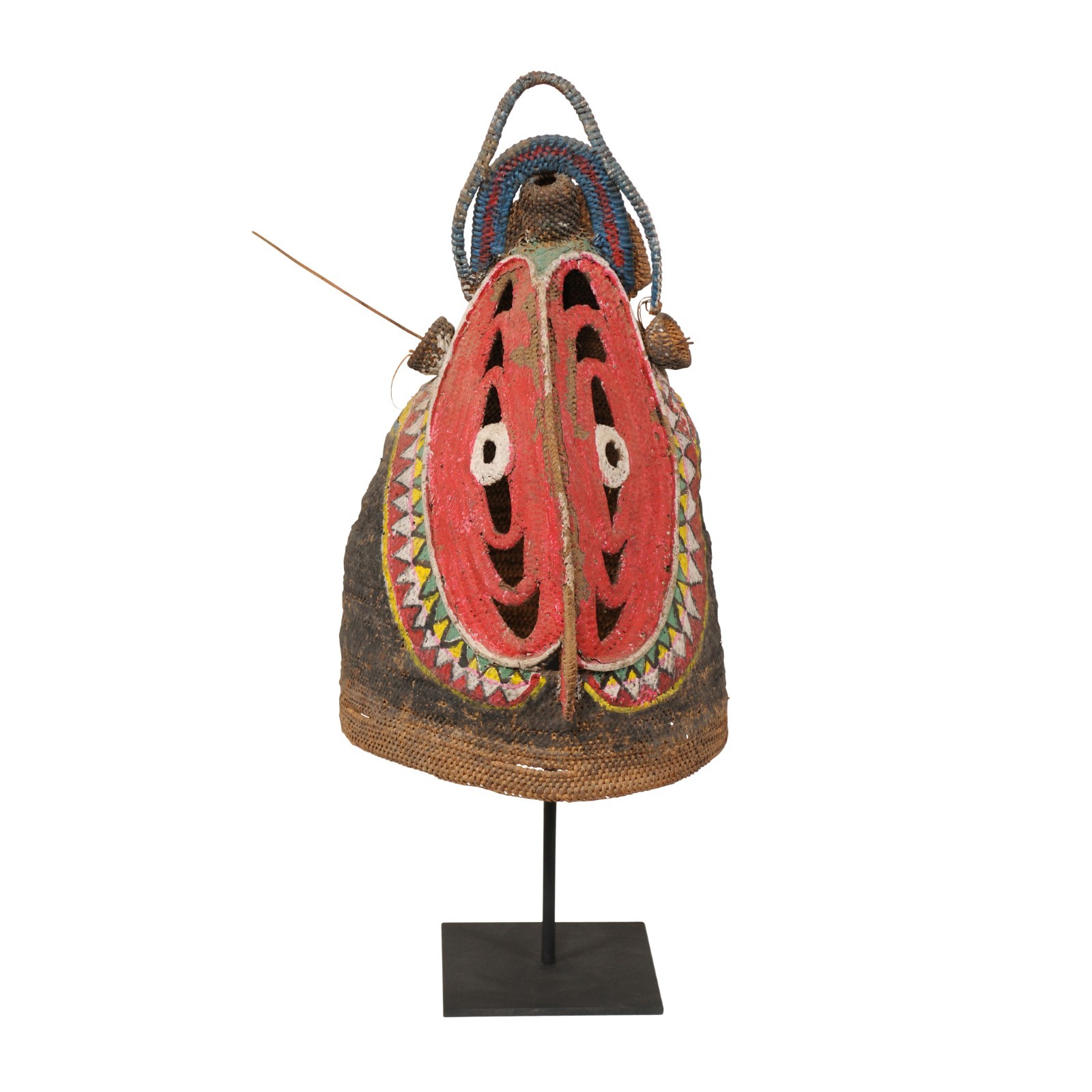 A Vibrantly Colored Baba Mask on Stand