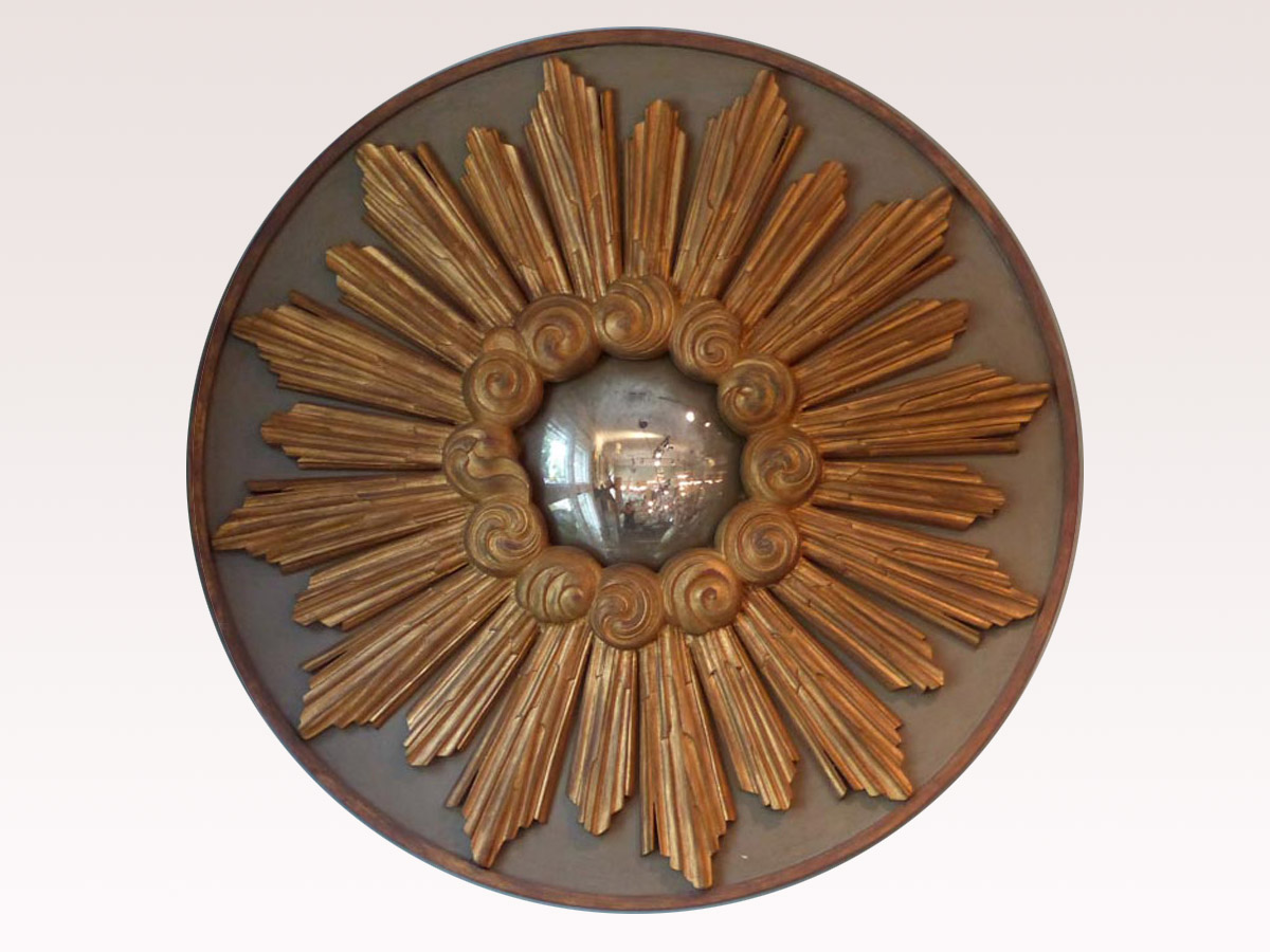 A Round Gilded Sunburst Mirror